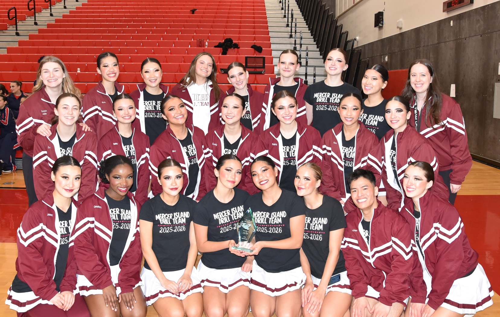 MI Drill Team celebrating with a trophy
